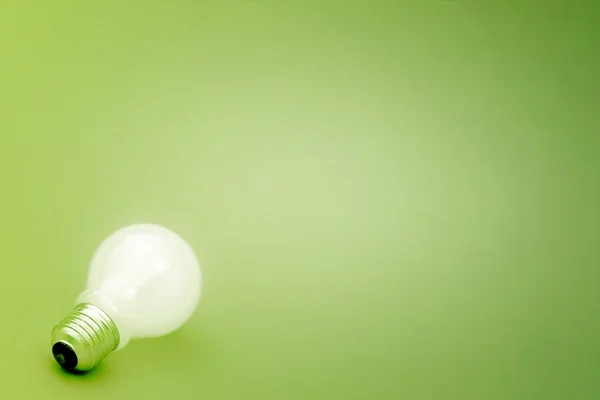 Background with lit lightbulb — Stock Photo, Image