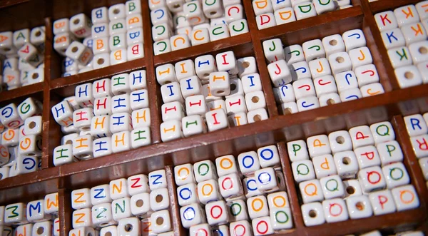 Wooden Tray of Ceramic Beads of the Alphabet — Stock Photo, Image