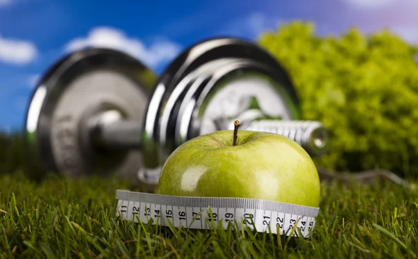 Apple with measuring of dumbbell — Stock Photo, Image