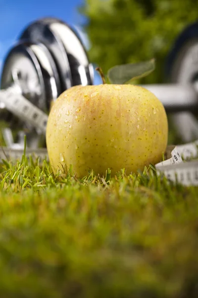Apple with measuring of dumbbell — Stock Photo, Image