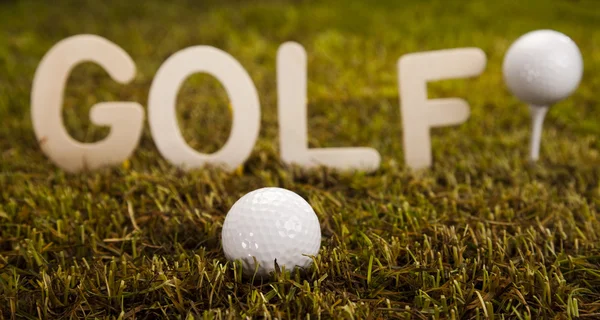 Golf ball on green grass over a blue sky — Stock Photo, Image