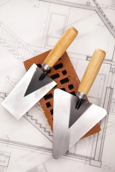 Brick, trowel tool and Construction plans — Stock Photo, Image