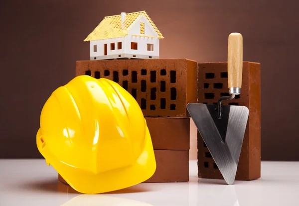 Brick, yellow hard hat, tools — Stock Photo, Image