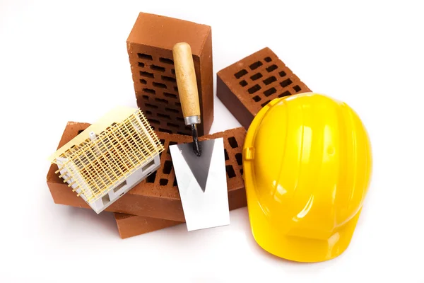 Brick, yellow hard hat, tools — Stock Photo, Image