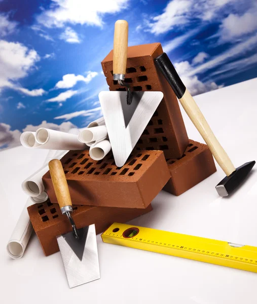 Brick, trowel tool and Construction plans — Stock Photo, Image