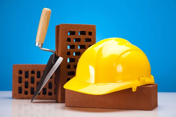 Brick, yellow hard hat, tools — Stock Photo, Image