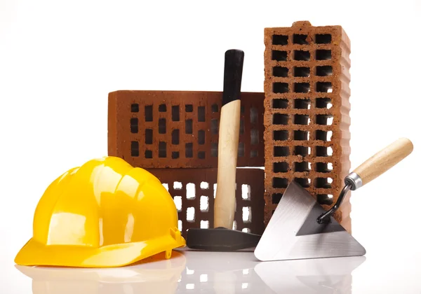 Hard hat with bricks and trowel — Stock Photo, Image