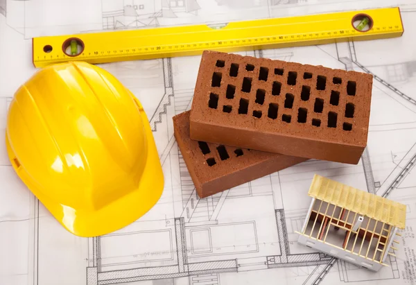 Hard hat with bricks and trowel — Stock Photo, Image