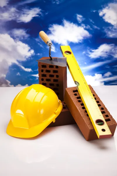Brick, yellow hard hat, tools — Stock Photo, Image