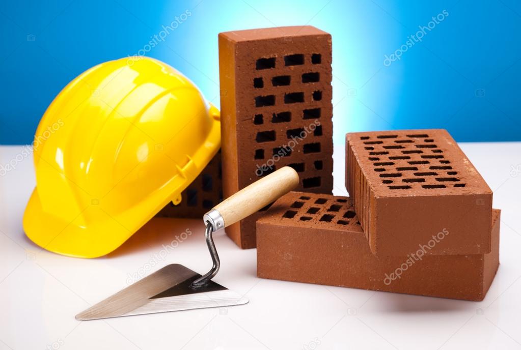 Hard hat with bricks and trowel