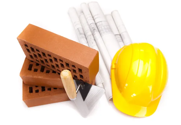 Brick, trowel tool and Construction plans — Stock Photo, Image