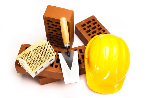 Brick, yellow hard hat, tools — Stock Photo, Image