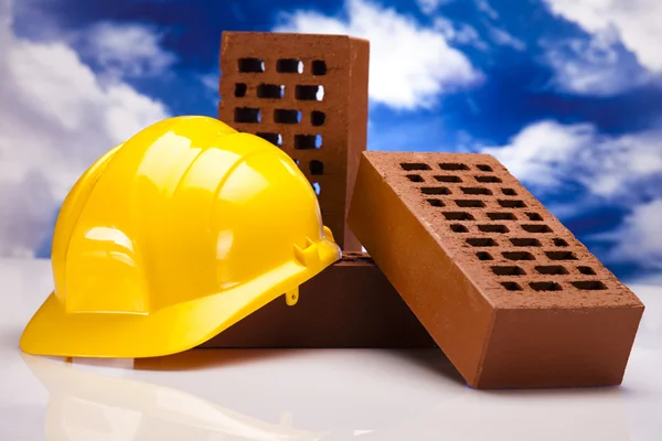 Hard hat with bricks and trowel — Stock Photo, Image