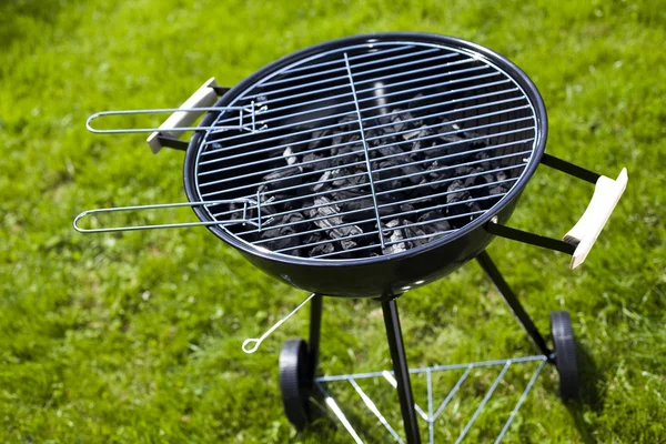 Grill on green grass — Stok fotoğraf