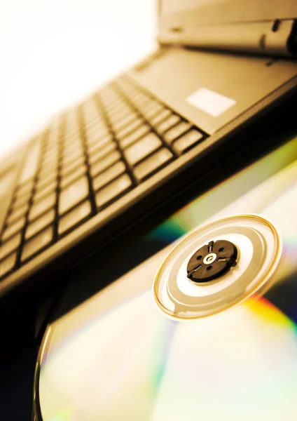Laptop with a disc — Stock Photo, Image