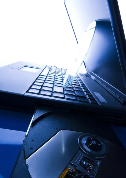 Laptop with a disc — Stock Photo, Image