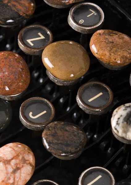 Typewriter with stones — Stock Photo, Image