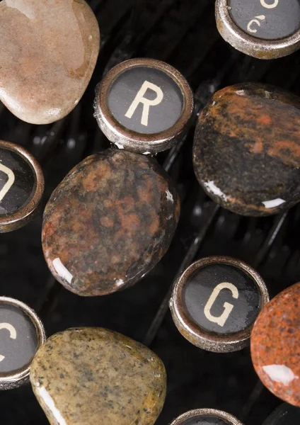 Typewriter with stones — Stock Photo, Image