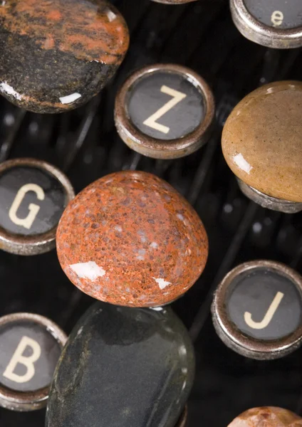 Typewriter with stones — Stock Photo, Image