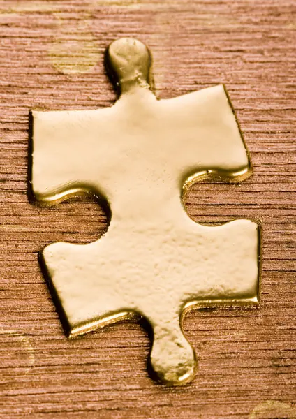 Puzzle on a wooden table — Stock Photo, Image