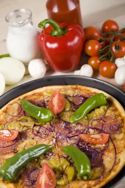 Vegetables with a pizza — Stock Photo, Image