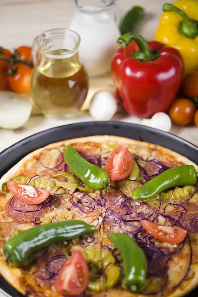Vegetables with a pizza — Stock Photo, Image