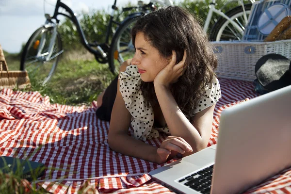 Girl on a picnic with laptop — Stock Photo, Image