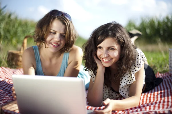 Girlfriends with laptop — Stock Photo, Image