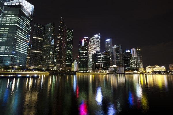 Singapore business district with waterfront at night