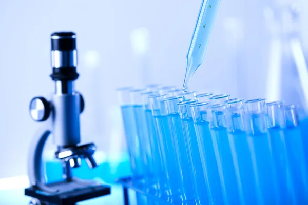 Test-tubes and microscope — Stock Photo, Image