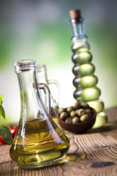 Olive oil with green olives — Stock Photo, Image