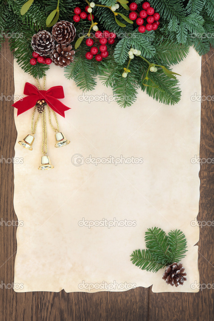 Old scroll on parchment paper with winter holly berry leaf sprigs