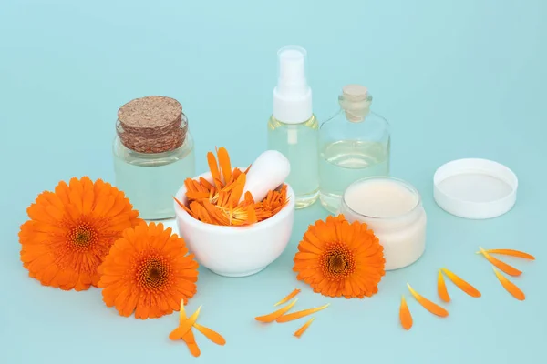 Calendula natural skincare preparation with flowers, moisturiser, oil bottles. Heals wounds, acne, eczema, stimulates collagen, is antiseptic, anti inflammatory, anti bacterial, anti fungal.