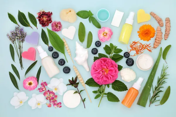 Herbs, flowers, ingredients and products for natural vegan skincare with anti aging benefits. Can ease psoriasis, acne and eczema skin problems. On blue background.