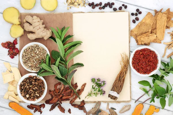 Alternative plant medicine to boost immune system with herbs, spice on  old hemp notebook on rustic wood. Health care concept with foods high in antioxidants, anthocyanins, vitamins and minerals.