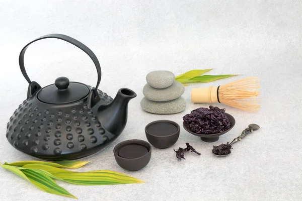 Dulse herbal drink for Japanese tea ceremony with ceramic tea set, whisk, pebble stack. Healthy beverage and mindfulness balance concept. Good for heart health.