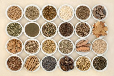 Nervine health food and herb collection in bowls. Heals the nervous system calms anxiety and stress. Healthy natural adaptogen alternative health care. On hemp paper.