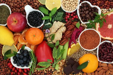 Health food for a healthy heart high in flavonoids, polyphenols, fibre, protein. Also high in antioxidants, anthocyanins, vitamins, bioflavonoids, minerals, lycopene. Flat lay. clipart
