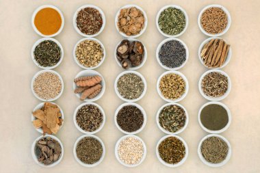 Nervine food herbal plant medicine to calm the nervous system of anxiety and stress. Healthy natural alternative health care. Large collection in bowls on hemp paper.