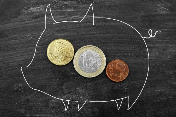 Coin into a piggy bank — Stock Photo, Image
