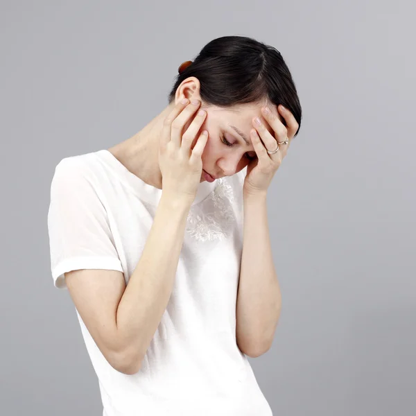 Sad woman isolated on grey background — Stock Photo, Image