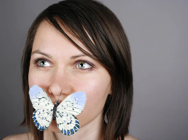 Mariposa en los labios —  Fotos de Stock