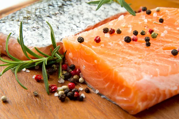 Fresh salmon fillet on wooden board — Stock Photo, Image