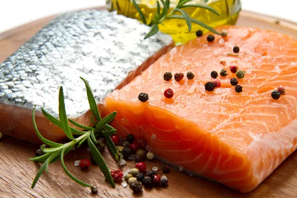 Fresh salmon fillet on wooden board — Stock Photo, Image