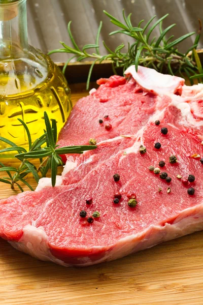 Raw T-bone with rosemary — Stock Photo, Image