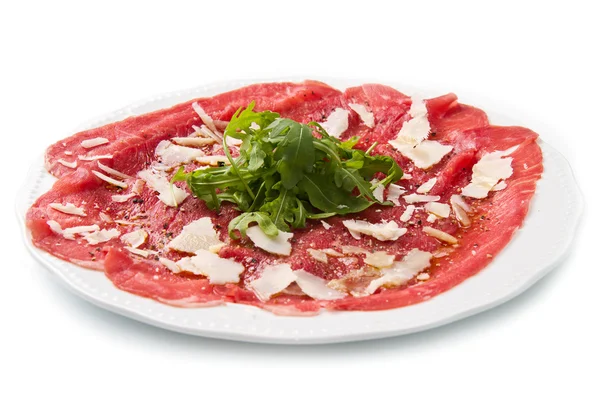 Carpaccio of beef on arugula — Stock Photo, Image