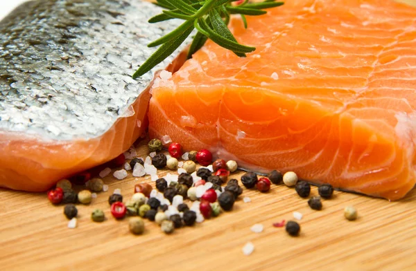 Fresh salmon fillet on wooden board — Stock Photo, Image