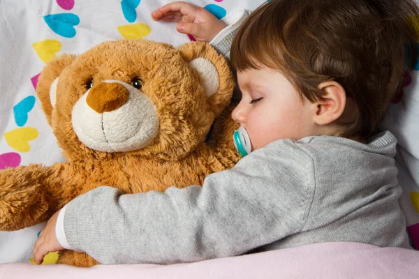 Sweet child sleeping with teddy bear — Stock Photo, Image