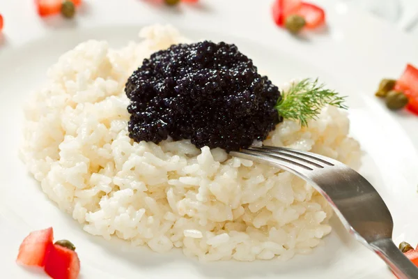 Rice with black caviar — Stock Photo, Image