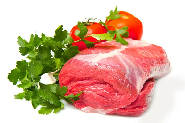 Stuk van ruwe rundvlees met peterselie en tomaten - geïsoleerd op wit — Stockfoto